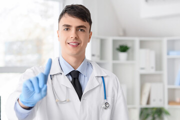 Male doctor using virtual screen in clinic, closeup