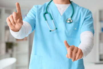 Male doctor using virtual screen in clinic, closeup