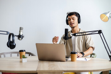 Man Streaming Online Podcast in Home Studio Using Audio Broadcasting Equipment