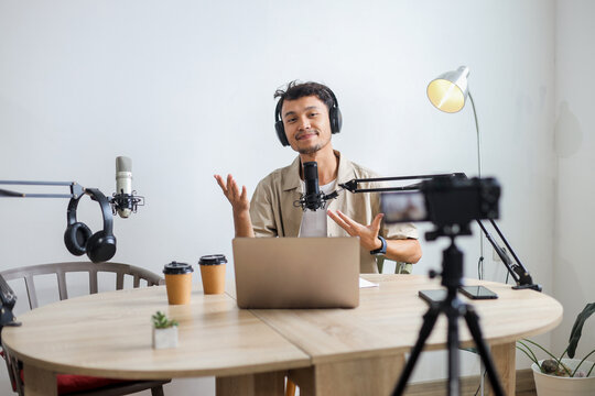 Male Podcaster Making Video Podcast From Home Studio Using Professional Camera - Powered by Adobe