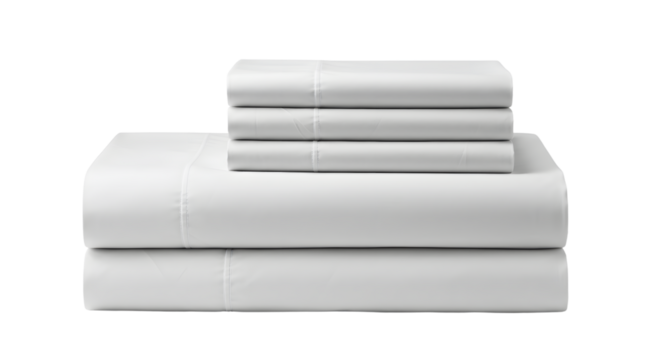 Neatly arranged white bed sheets stacked on a plain surface, showcasing softness and simplicity for home decor