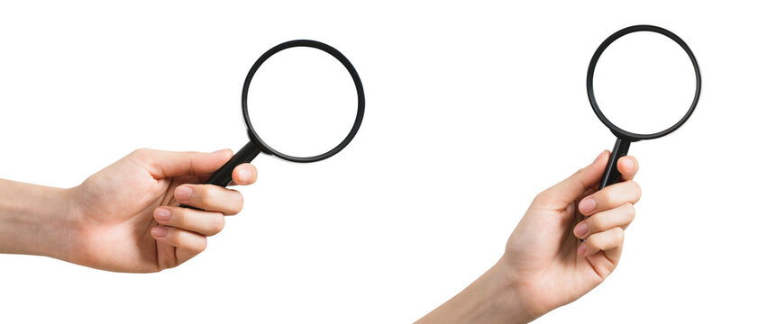 Hand holding magnifying glass isolated on white background.