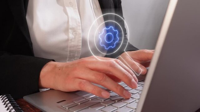 A businesswoman typing on her laptop, with a glowing gear icon floating with a magnifying glass above the keyboard in front of her, symbolizing system integration and lighting effects to highlight det