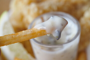Delicious fries dipped in creamy sauce at a casual eatery