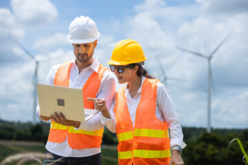 man and women engineer worker wind turbine handshake success agreement survey discuss operational planning. Windmill field clean energy sustainable clean. engineering nature power alternative.