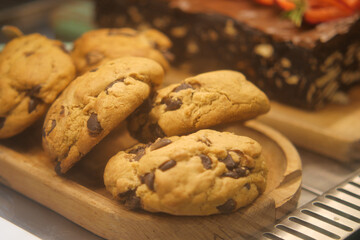 Delicious chocolate chip cookies on a wooden plate