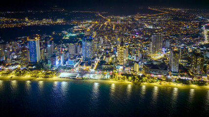 Fototapeta premium Aerial view of Nha Trang city at night. This is a famous city for cultural tourism in central Vietnam