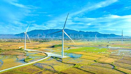Panoramic view of wind farm or wind park. Wind turbines generating electricity on rice field at Phan Rang, Ninh Thuan, Vietnam. Clean energy concept