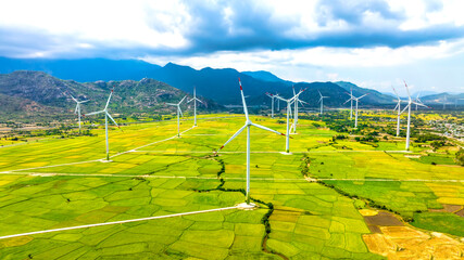 Panoramic view of wind farm or wind park. Wind turbines generating electricity on rice field at Phan Rang, Ninh Thuan, Vietnam. Clean energy concept