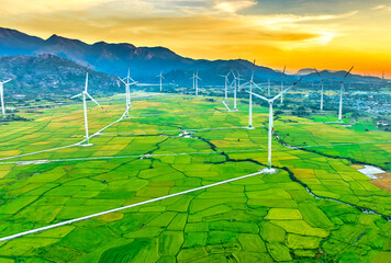 Panoramic view of wind farm or wind park. Wind turbines generating electricity on rice field at Phan Rang, Ninh Thuan, Vietnam. Clean energy concept