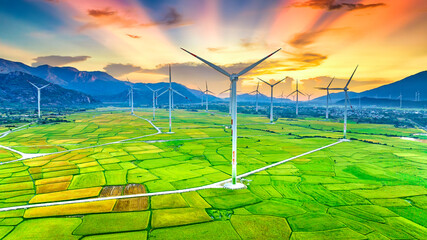 Panoramic view of wind farm or wind park. Wind turbines generating electricity on rice field at Phan Rang, Ninh Thuan, Vietnam. Clean energy concept