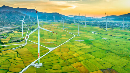 Panoramic view of wind farm or wind park. Wind turbines generating electricity on rice field at Phan Rang, Ninh Thuan, Vietnam. Clean energy concept