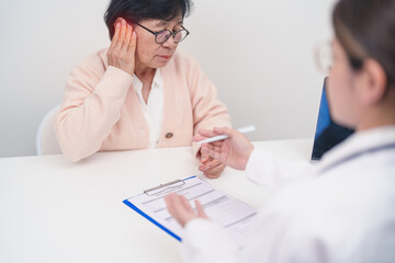 Elderly woman Patient having Earache and consulting Doctor to Ear disease. Senior Health Medical Diagnosis. Atresia, Otitis Media, Pertorated Eardrum, Meniere syndrome, otolaryngologist, Hearing Loss