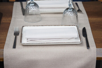 Elegant dining setup with white dishes and glassware