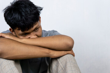 Portrait Of Depressed Young Indonesian Man, Suffering Life Problems Or Mental Breakdown, Feeling...