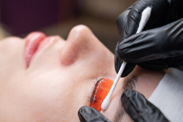 Caucasian woman undergoing eyelash lamination procedure. 