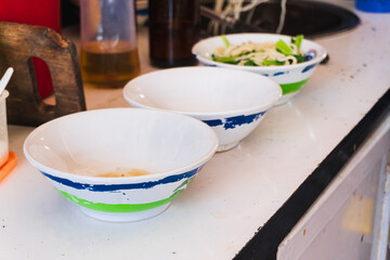 Preparing chicken noodles. View of a chicken noodle seller who is making chicken noodles for the buyer.