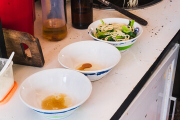 Preparing chicken noodles. View of a chicken noodle seller who is making chicken noodles for the buyer.