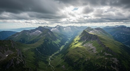 Aerial View of Mountain Valley with River and Cloudy Sky