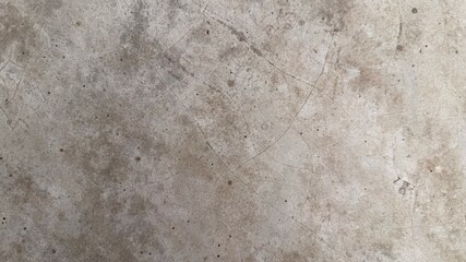The weathered concrete surface is showing fine cracks and spots in a detailed texture