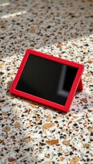 Red Silicone Tablet Case on Terrazzo Surface