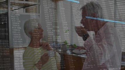 Couple sipping and gesturing in kitchen initiating animated code overlay showing tech data flow - Powered by Adobe