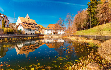 Fototapeta premium Alpine spring view with reflections in a pond at Lengmoos, Ritten, South Tyrol, Italy