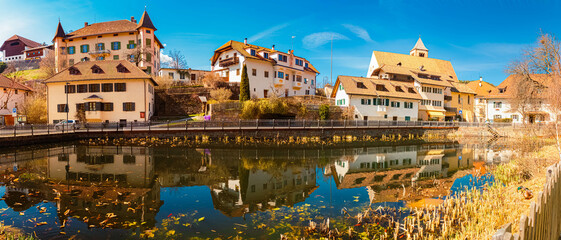 Fototapeta premium Alpine spring view with reflections in a pond at Lengmoos, Ritten, South Tyrol, Italy