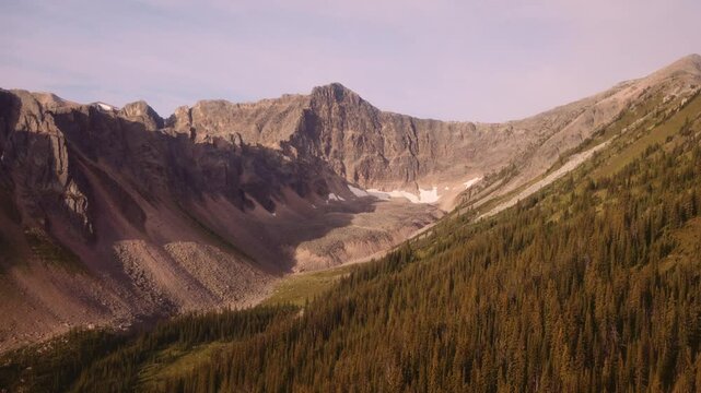 Aerial helicopter shot heading up towards Purcell Mountain outside Golden, BC, in the summer season.