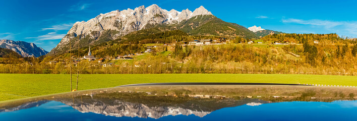 High resolution stitched alpine spring panorama with reflections on a car roof near Pfarrwerfen,...