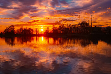 Obraz premium Spring sunset or sundowner view with reflections near Plattling, Isar, Deggendorf, Bavaria, Germany