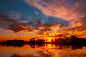 Spring sunset or sundowner view with reflections near Plattling, Isar, Deggendorf, Bavaria, Germany