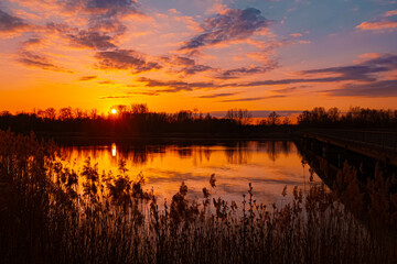 Naklejka premium Spring sunset or sundowner view with reflections near Niederpoering, Isar, Oberpoering, Deggendorf, Bavaria, Germany