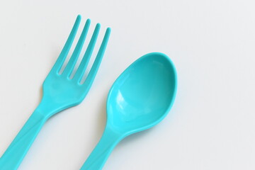 blue spoon and fork isolated on white background, plastic cutlery for picnic