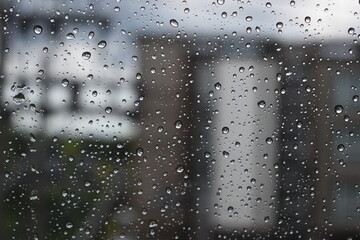 water drop on mirror with blue sky and building