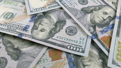 A collection of scattered US Dollar Bills laid out on a surface for viewing and counting