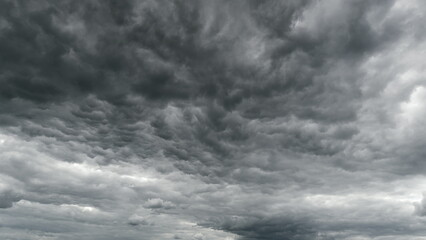 The sky above is filled with dramatic overcast conditions, featuring dark and thick clouds Time...