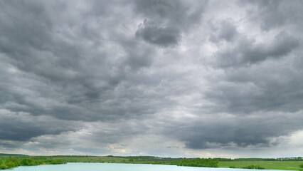 Dramatic and Overcast Skies Hovering Over a Beautifully Tranquil River Landscape Scene Time lapse.