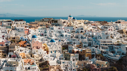 Stunning Santorini Greece village with iconic white buildings, blue domes & Aegean Sea views....