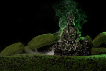 Homemade buddha statue with fake moss and grass surrounded with swirling mist and fog Handmade and...