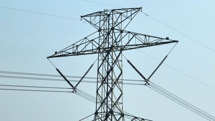 A tall power transmission tower carrying high-voltage lines, emphasizing the infrastructure required for large-scale energy distribution.
