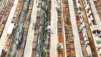 An aerial view of the precast factory, showing organized lines of industrial molds, along with weathered equipment, signifying heavy-duty production in action.
