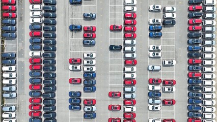 From above, the wide expanse of parked vehicles shows the intricate logistics involved in handling a large inventory of cars, with each car positioned for easy movement and swift transportation.
