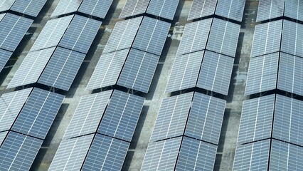 From above, the orderly rows of solar panels demonstrate the efficiency of solar energy systems in harnessing the sun's power, turning solar radiation into electricity for the grid.
