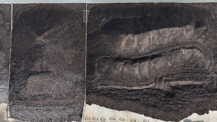From above, the image illustrates the collection and sorting of glass waste in a recycling plant,...