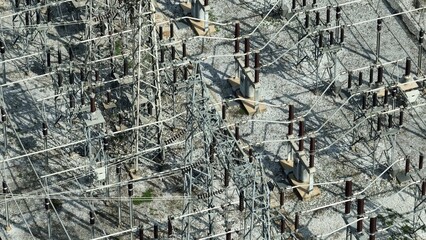 An aerial perspective of a power station, featuring electrical grids and towers that help transport...