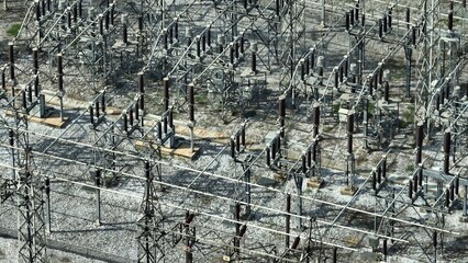 Aerial view showcasing high-voltage electrical equipment, power lines, and insulators, emphasizing...