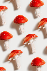 Minimal aesthetic pattern with fly agaric mushrooms, natural beauty of inedible toxic and hallucinogenic mushroom with bright red caps and white stems names Amanita muscaria, creative photo