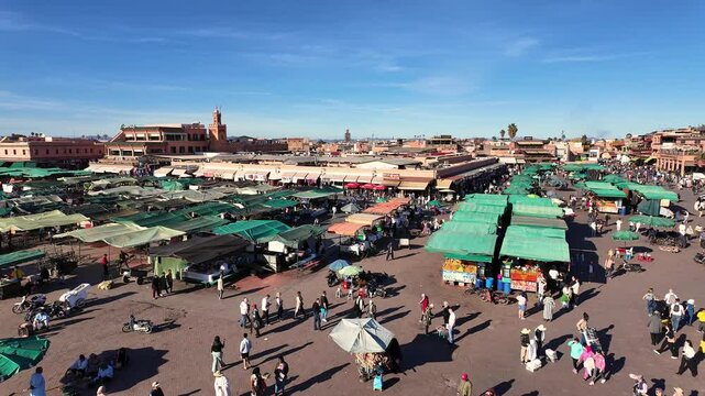 Marrakesh, Morocco: Panoramic footage of tourists who visit the famous Jemaa el-Fnaa in the heart of the Marrakesh old town Medina. 