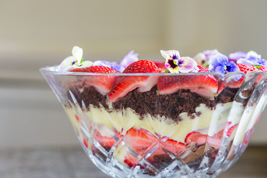 modern trifle dessert, made with chocolate brownie cake, custard and strawberry